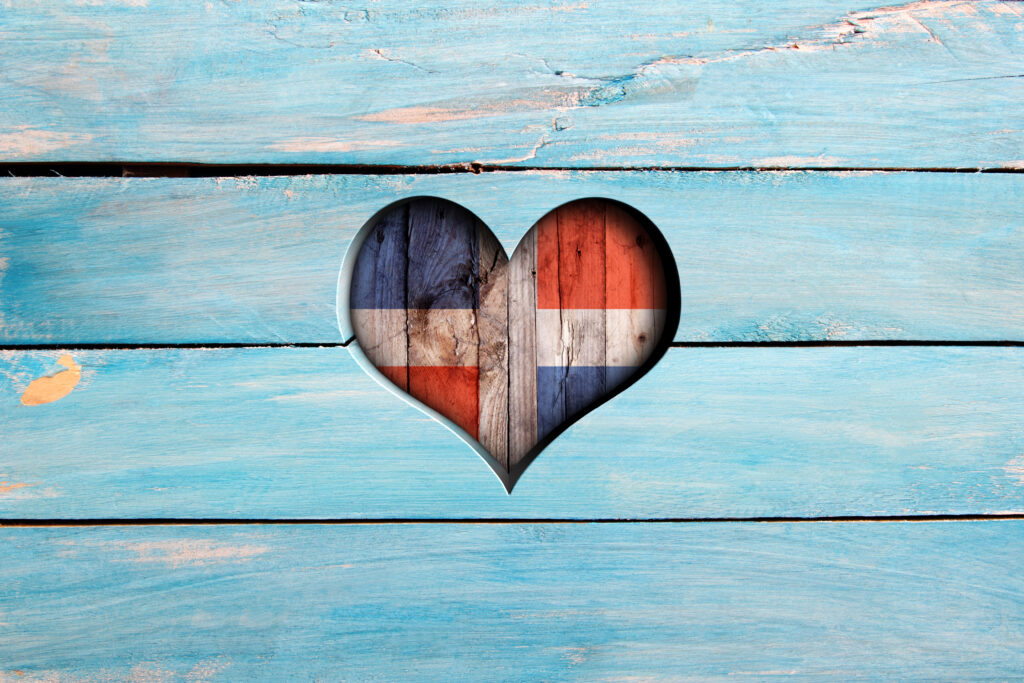 Love Dominican Republic. Heart and flag on a blue wooden board
